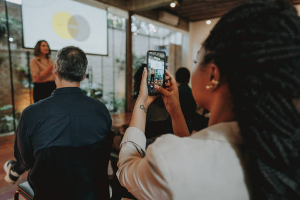 istock Making photo of speaker during conference with smartphone 1496375814