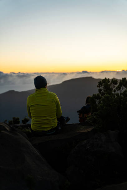 istock Sitting and watching a beautiful dusk over tall mountains vertical image 1496377244