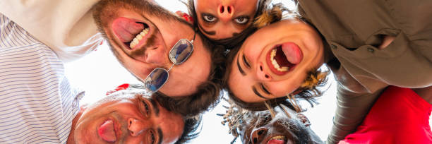 istock Multiracial group of young people stnding in circle and smiling at camera 1496377295