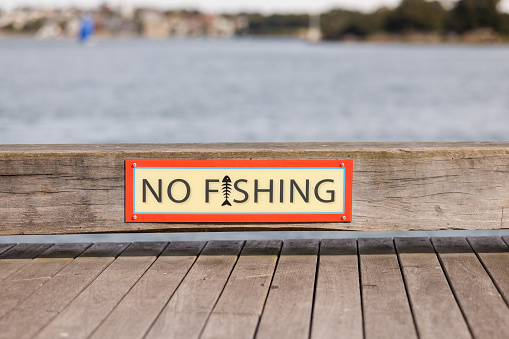 No fishing sign on a wooden pier