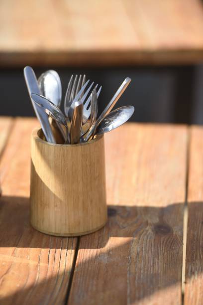 istock Brown wooden storage box on a wooden tabletop, filled with an array of kitchen utensils and spoons 1496380197