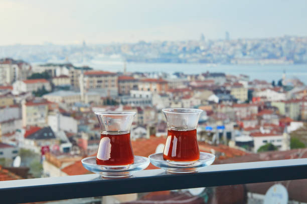 Two Turkish glasses filled with tea with view to the roofs of Uskudar district on Asian side of Istanbul, Turkey stock photo