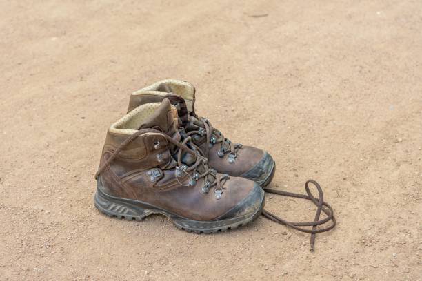 istock a boot on the sand, with a brown shoelacee 1496383576