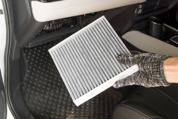 istock Auto mechanic replace car cabin air filter, Car maintenance service. 1496391224