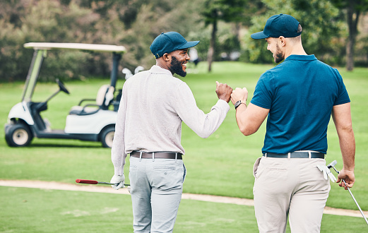 Man, friends and fist bump on golf course for sports, partnership or trust on grass field together. Happy sporty men bumping hands or fists in collaboration for good match, game or competition