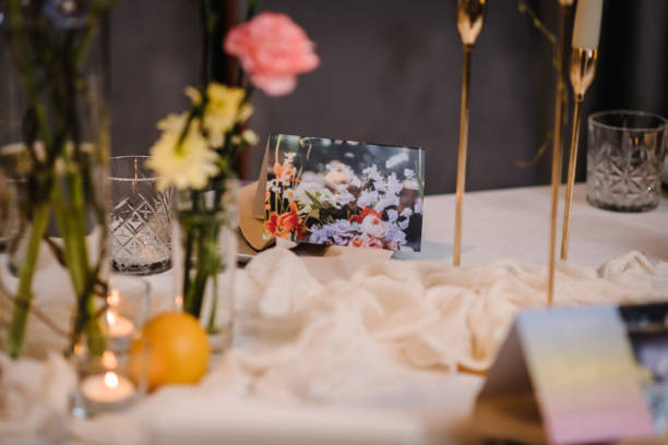 istock Luxury elegant table setting dinner in a restaurant. Selective focus on glasses. Preparation before the banquet table for a birthday. Wedding reception. Decor of flowers, greenery and candles. Closeup 1496392528