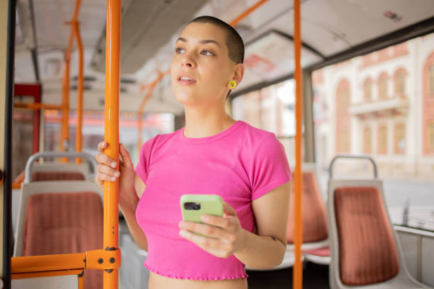 istock Happy young woman riding public transportation 1496392620