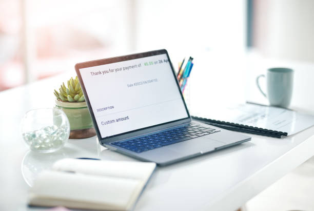 istock Online payment confirmation, laptop and empty office with ecommerce pay slip from web shopping. Digital, checkout notification and computer transaction sale on a website with isolated workspace 1496394028