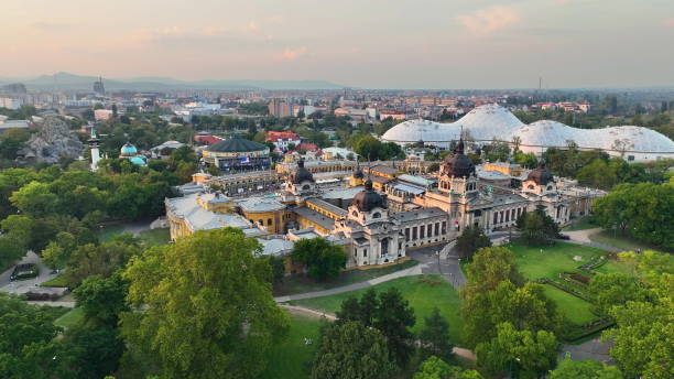 istock 4K aerial drone view Szechenyi Bath. Drone flies around pool with many visitors. Budapest, Hungary 1496394245