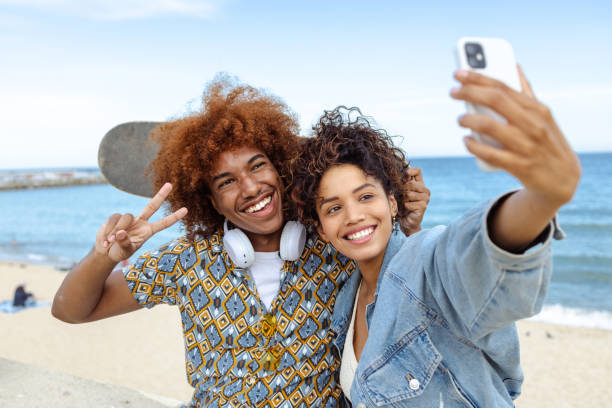 istock Young people taking selfie by the sea 1496397117