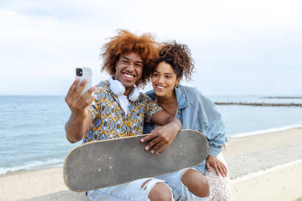 istock Young people taking selfie by the sea 1496397186
