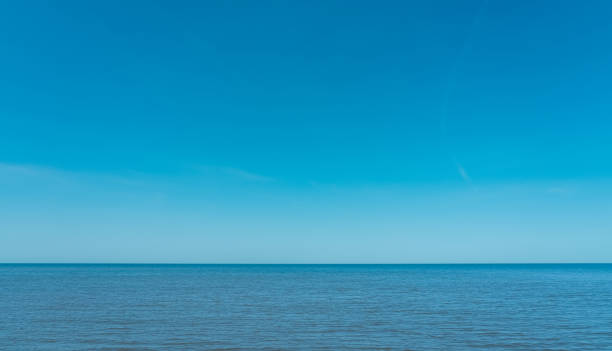 istock Summer Blue Sky Over Blue Ocean Background,Beautiful Nature Tropical Beach with Clear Sky and White Clouds Abstract Texture with Copy Space,Summer vacation or holiday business travel banner concept 1496402961