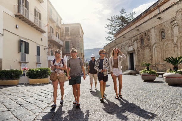 Multi generation family walking in a charming piazza of Tropea