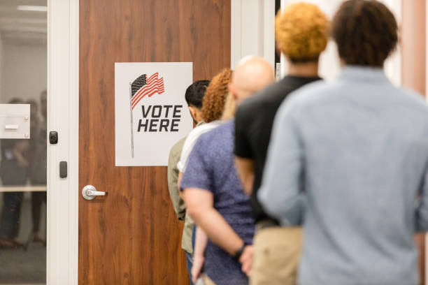 istock Unrecognizable multiracial group waits patiently to vote 1496405355