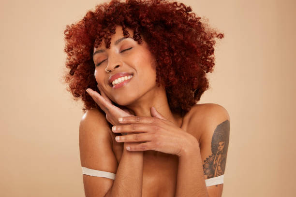 istock Beautiful young woman putting on crea 1496406232