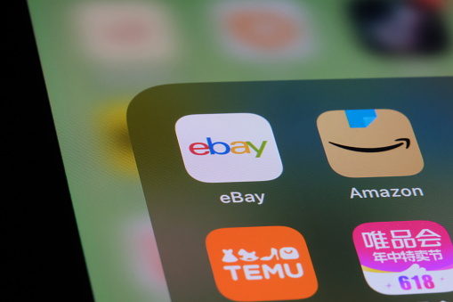 Shanghai,China-May 21st 2023: close up eBay, Amazon, Temu and Vipshop app icon on screen. E-commerce company and brand