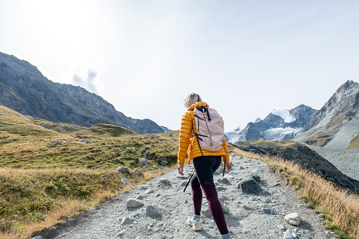 Woman hiking in Summer in Switzerland, beautiful mountain landscape