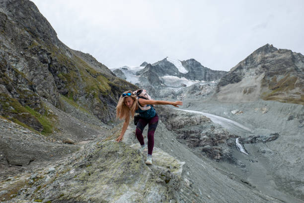 istock Sporty female hiking on mountain ridge, she balances 1496407270
