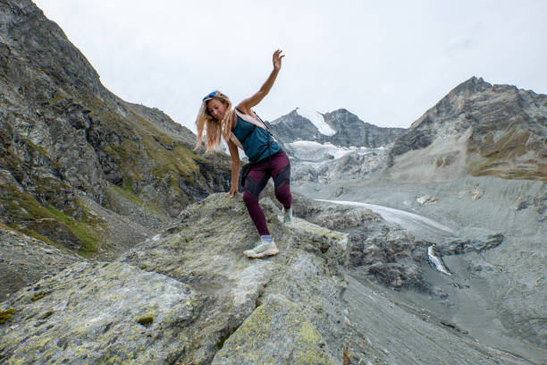 istock Sporty female hiking on mountain ridge, she balances 1496407321