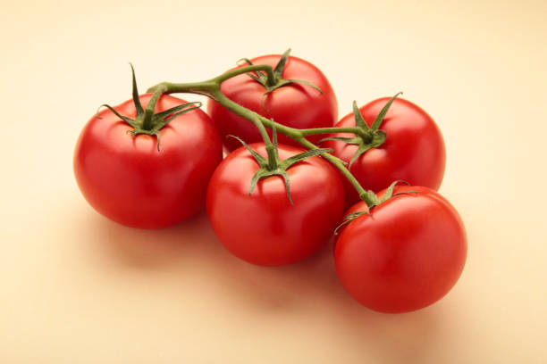 istock Flat lay composition with bunch of tomatoes on beige background. Space for text 1496411292