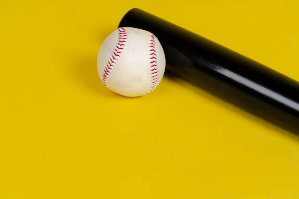 Baseball bat and ball on bright yellow background Baseball bat and ball on bright yellow background baseball bat home run baseball wood stock pictures, royalty-free photos & images