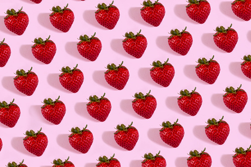 Strawberries On Pink Background.