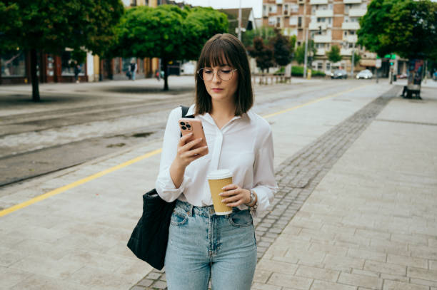 istock young woman going to work, city street 1496417809