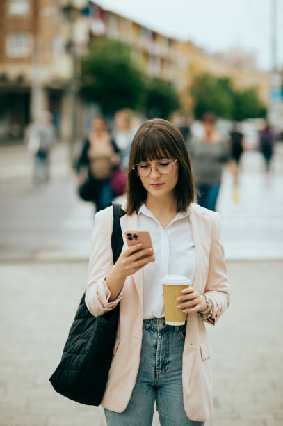 istock young woman going to work, city street 1496417821