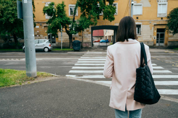 istock young woman going to work, city street 1496417837