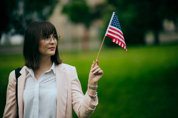 istock Woman's hand holding an American flag 1496417879