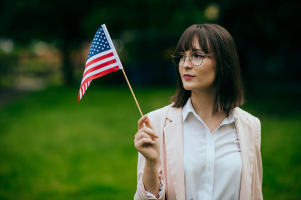 istock Woman's hand holding an American flag 1496417880