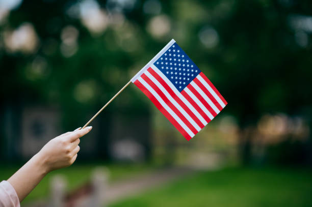 istock Woman's hand holding an American flag 1496417883