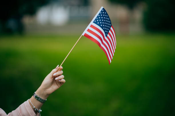 istock Woman's hand holding an American flag 1496417885