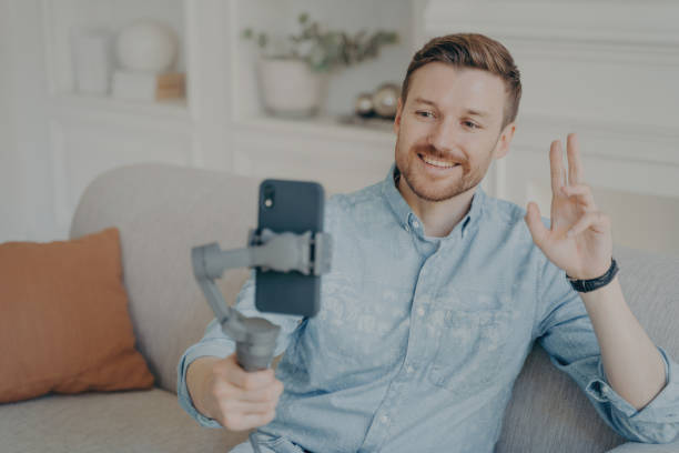 istock Young man talking with his friend through online video chat using telephone 1496418029