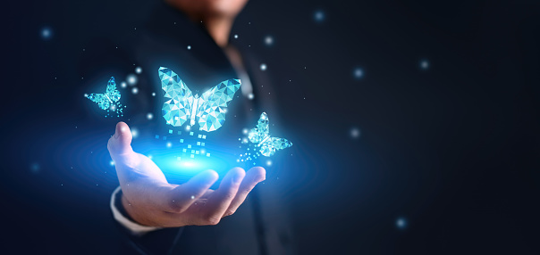 Blue Digital Butterfly effect on the businessman with glowing particles light. Global business economy and digital transformation concept. Connectivity and Virtual Reality theme. Copy space