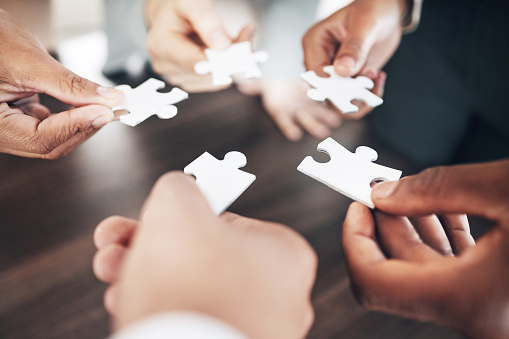 Business people, hands or puzzle for solution or problem solving with planning, teamwork or collaboration. Jigsaw, zoom or partnership support, project development ideas or community group mission