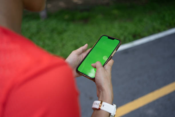 istock Sport woman in red shirt using mobile phone. 1496420924