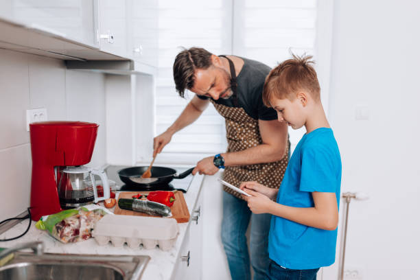 istock Mid Adult Man and Young Son Explore Flavorful Possibilities 1496423355