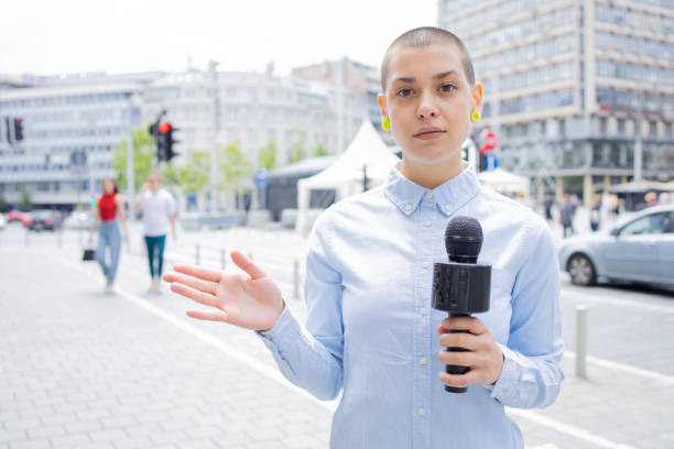 istock Young TV reporter broadcasting live 1496424245