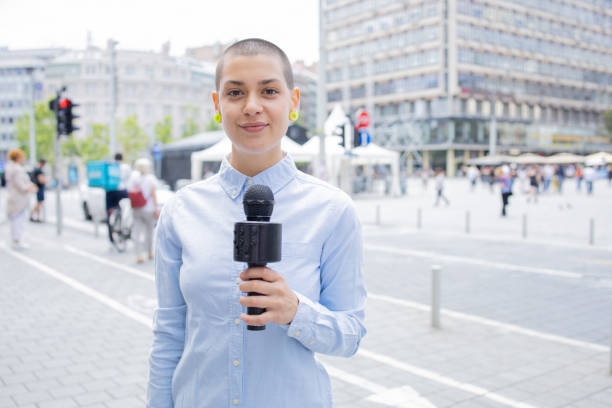 istock Young TV reporter broadcasting live 1496424246