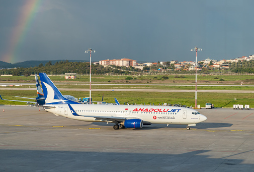 Izmir, Turkey - April 11, 2023: A picture of an AnadoluJet plane and a rainbow on the left side.