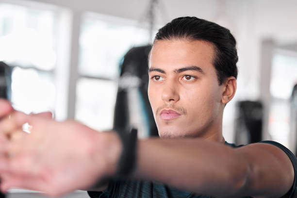 istock Hands, stretching fingers and man in gym ready to start workout, training or exercise. Sports fitness, thinking and serious male athlete warm up, stretch or prepare for exercising for flexibility. 1496424925
