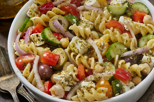 Greek Pasta Salad with Rotini, Feta, Cherry Tomatoes, Cucumber, Olives, Red Onion, Chick Peas and Red Peppers