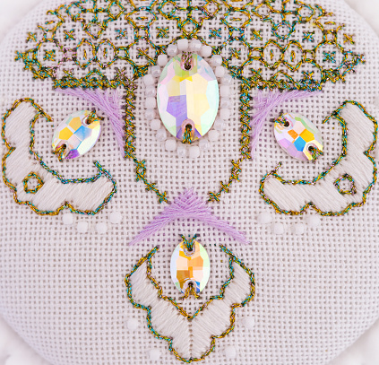 A handmade embroidery with white, purple and gold - green threads, white beads and crystals on it. 9. Close-up. This ornament was embroidered by myself. Design by Alexandra Tkacheva