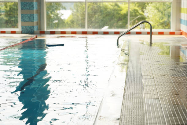 istock Against the background of the panoramic window is a swimming pool prepared for training without people. Clear blue water with dividing lines for swimming. With space to copy. High quality photo 1496433998