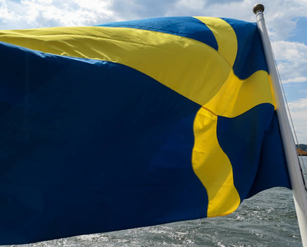 a close up of a swedish flag - day sky swedish flag banner imagens e fotografias de stock