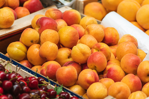 Farm-fresh peaches in a basket at a farmer's market