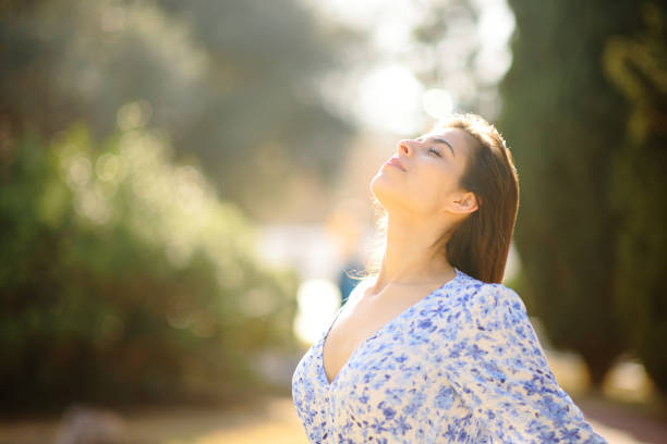 istock Woman breathing fresh air in a park alone 1496436883