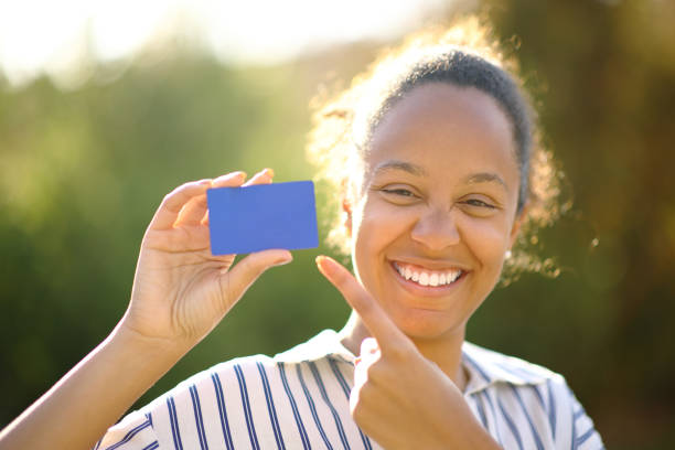 istock Happy black buyer showing blank credit card 1496436921