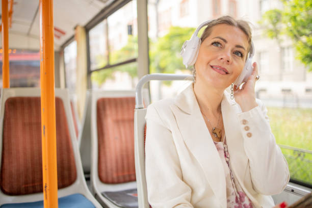 istock Happy mature woman riding public transportation 1496439192